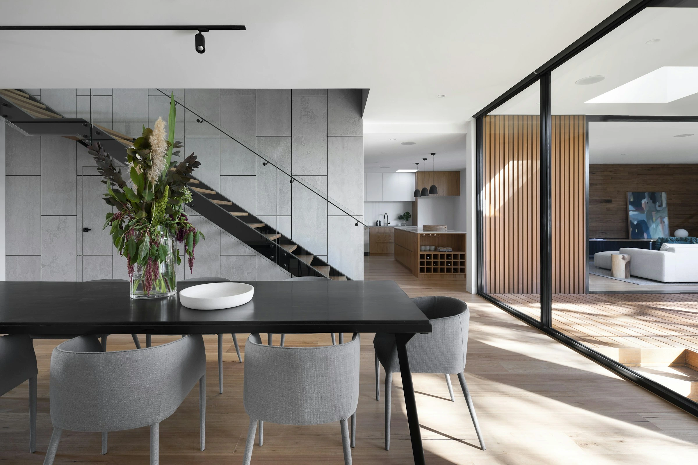 Architect-designed residence with a floating staircase, natural stone, and bespoke woodwork