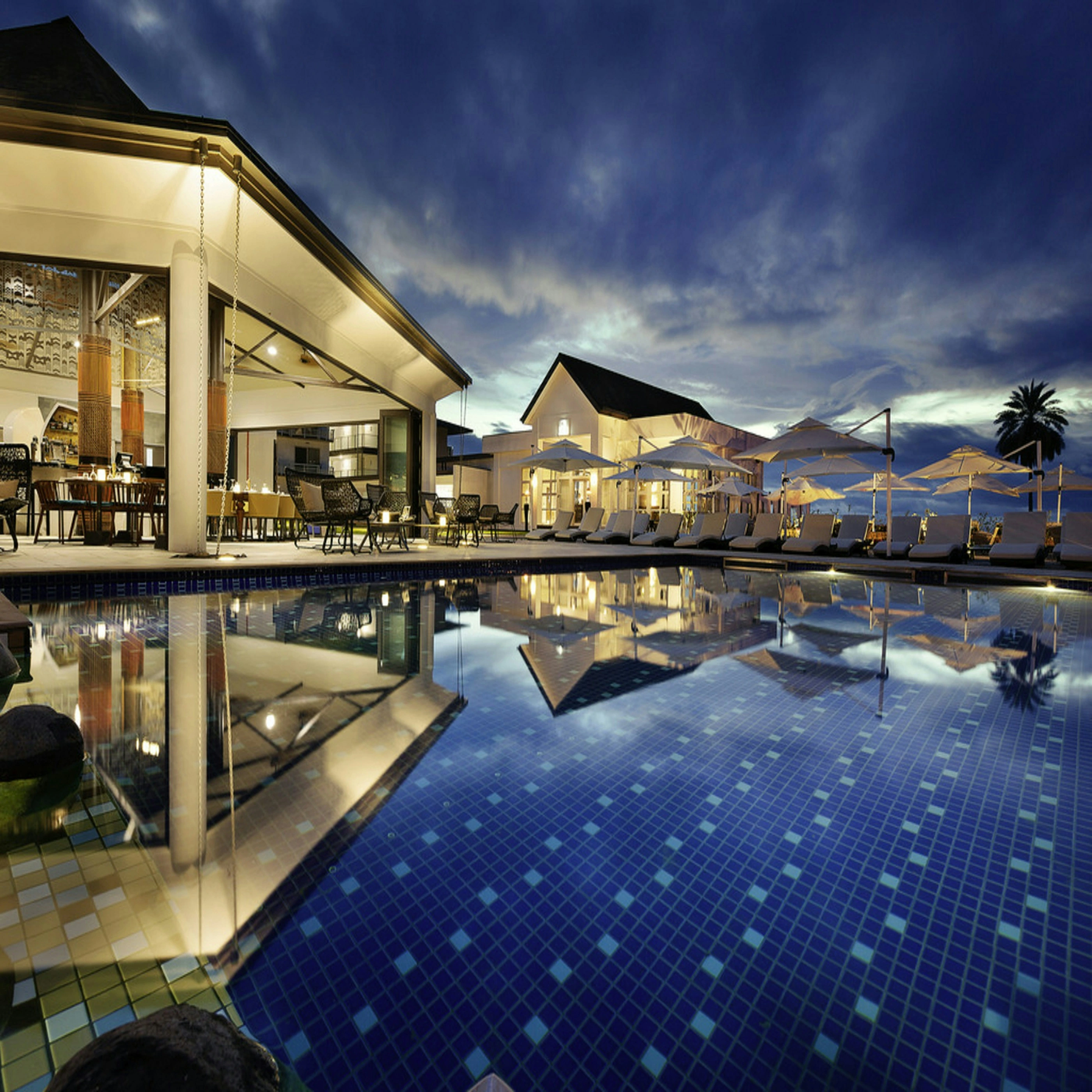 Luxury resort architecture and reflective pool at twilight